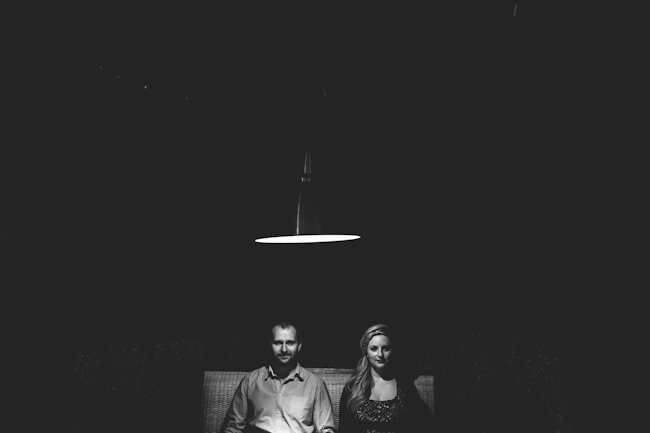 engagement photoshoot couple sitting in dark room