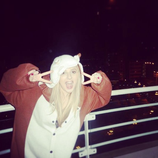 Bride on hen do in onesie on balcony of Wyndham Hotel