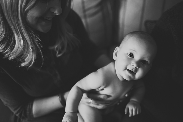 a family lifestyle photoshoot baby looking up at camera hollygoeslightly