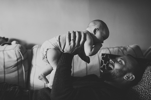 a family lifestyle photoshoot dad holding baby up hollygoeslightly
