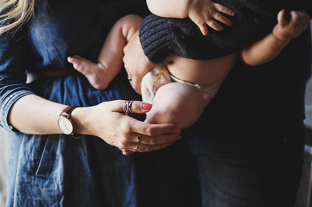 a family lifestyle photoshoot mum and dad holding baby hollygoeslightly