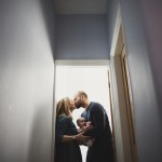 a family lifestyle photoshoot mum and dad holding baby kiss hollygoeslightly