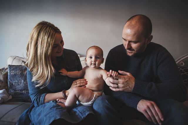 a family lifestyle photoshoot mum dad baby on couch hollygoeslightly