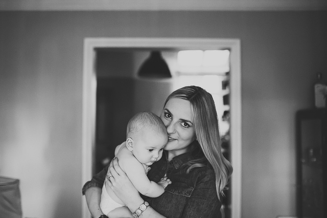 a family lifestyle photoshoot mum holding baby and looking at camera hollygoeslightly