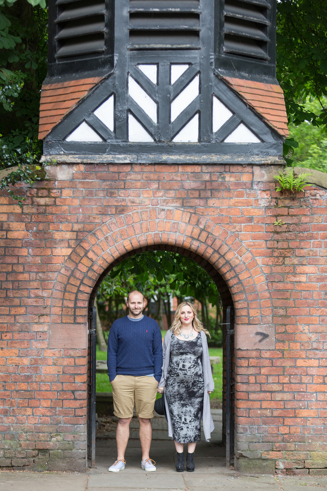 maternity photoshoot in the woods church gates holding hands hollygoeslightly