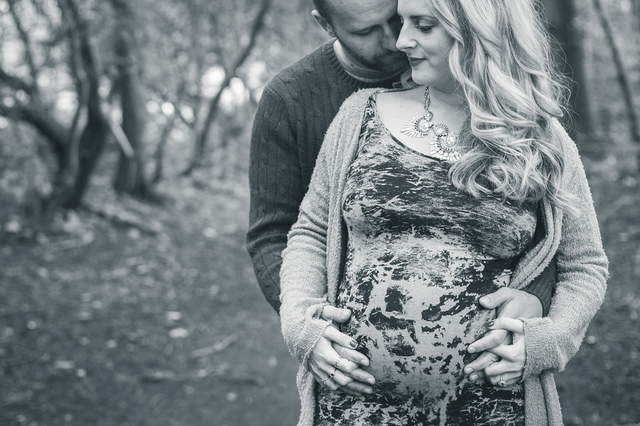 maternity photoshoot in the woods couple holding bump hollygoeslightly