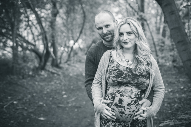 maternity photoshoot in the woods couple looking at camera hollygoeslightly
