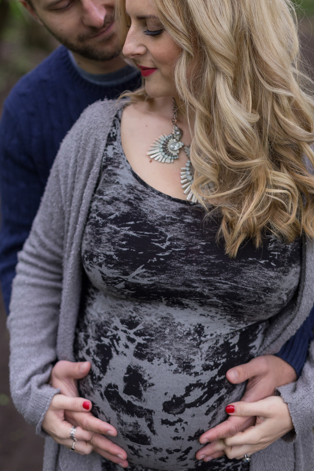 maternity photoshoot in the woods holding baby bump hollygoeslightly
