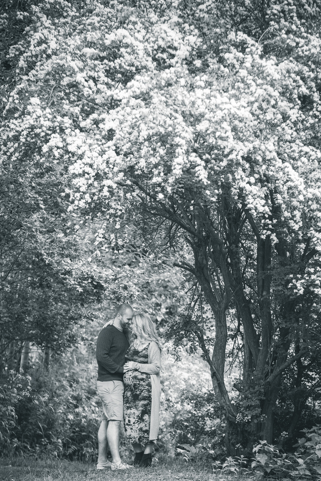 maternity photoshoot in the woods smiling hugging hollygoeslightly