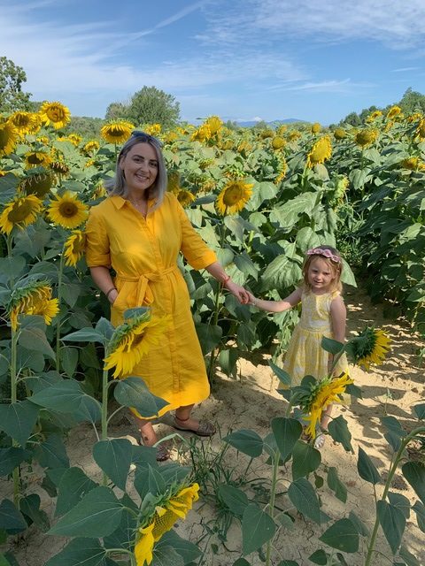 mum and daughter matching dresses boden sunflower fields holding hands